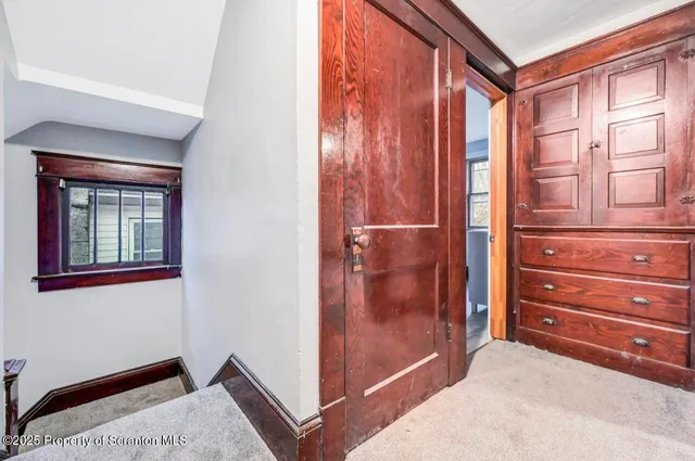 a view of a balcony with a large window and wooden floor