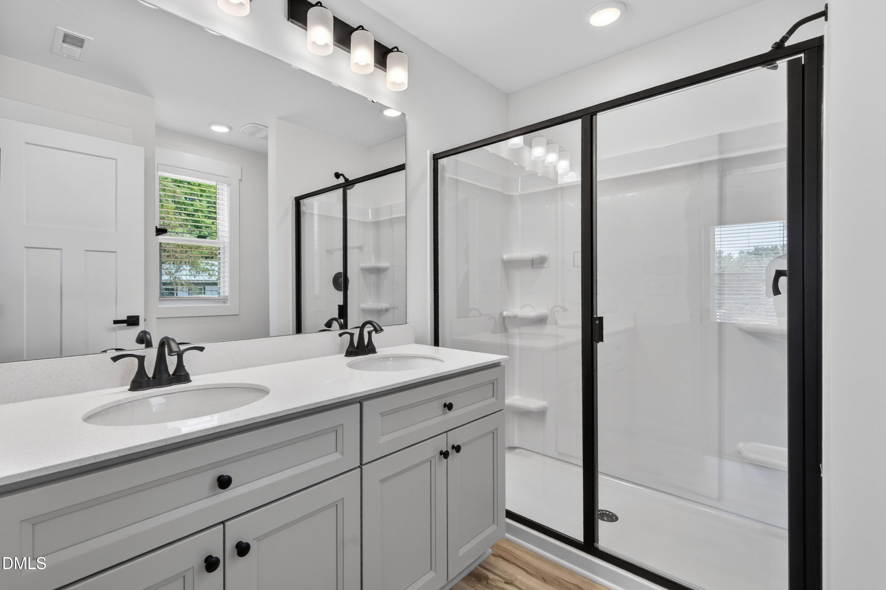 1182 Hurdle Mills Road Roxboro, NC 27573 - Photo 28 of 45 a bathroom with a double vanity sink mirror and shower