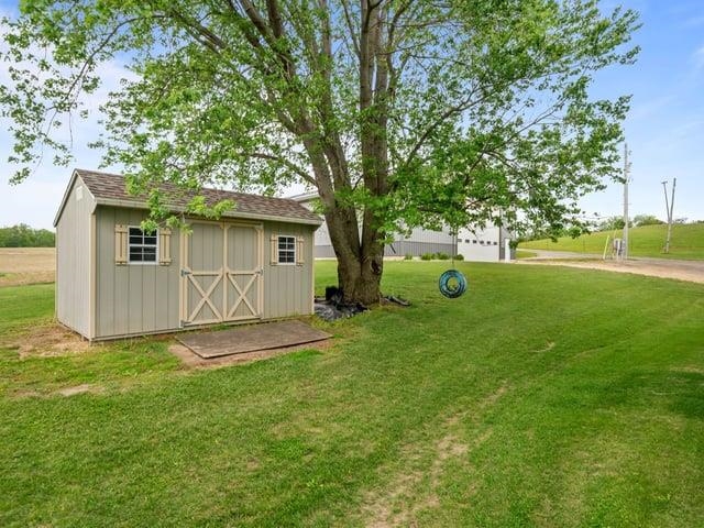 8294 North Leaf River Road Leaf River, IL 61047 - Photo 53 of 56 a view of a house with backyard and a tree