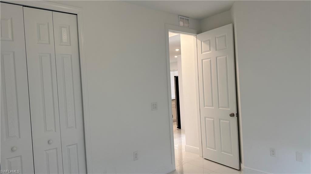 5901 Rita Avenue North Lehigh Acres, FL 33971 - Photo 20 of 22 a bathroom with a glass shower door
