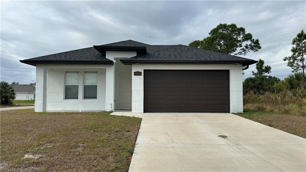 5901 Rita Avenue North Lehigh Acres, FL 33971 - Photo 2 of 22 a front view of a house with a garage