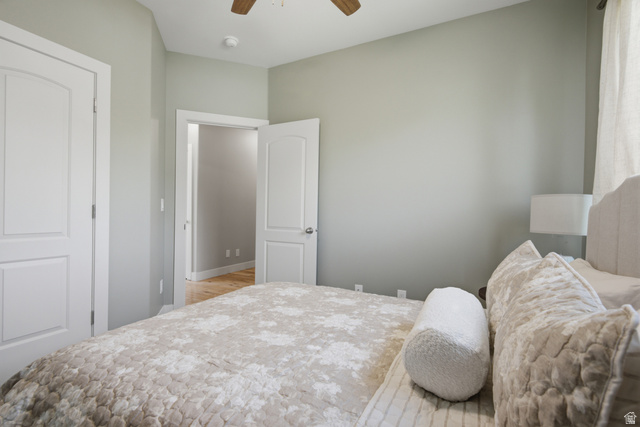 1252 Skyline Road Saratoga Springs, UT 84045 - Photo 23 of 51 Bedroom featuring light gray wall paint, two white paneled doors, and a ceiling fan with wood-finish blades