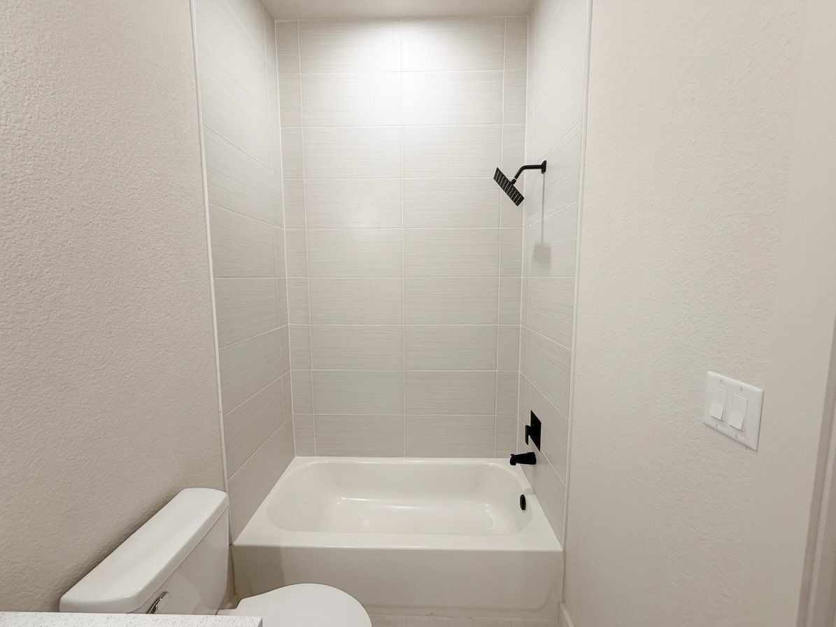9738 Garcroft Street Houston, TX 77029 - Photo 8 of 17 a bathroom with a bathtub