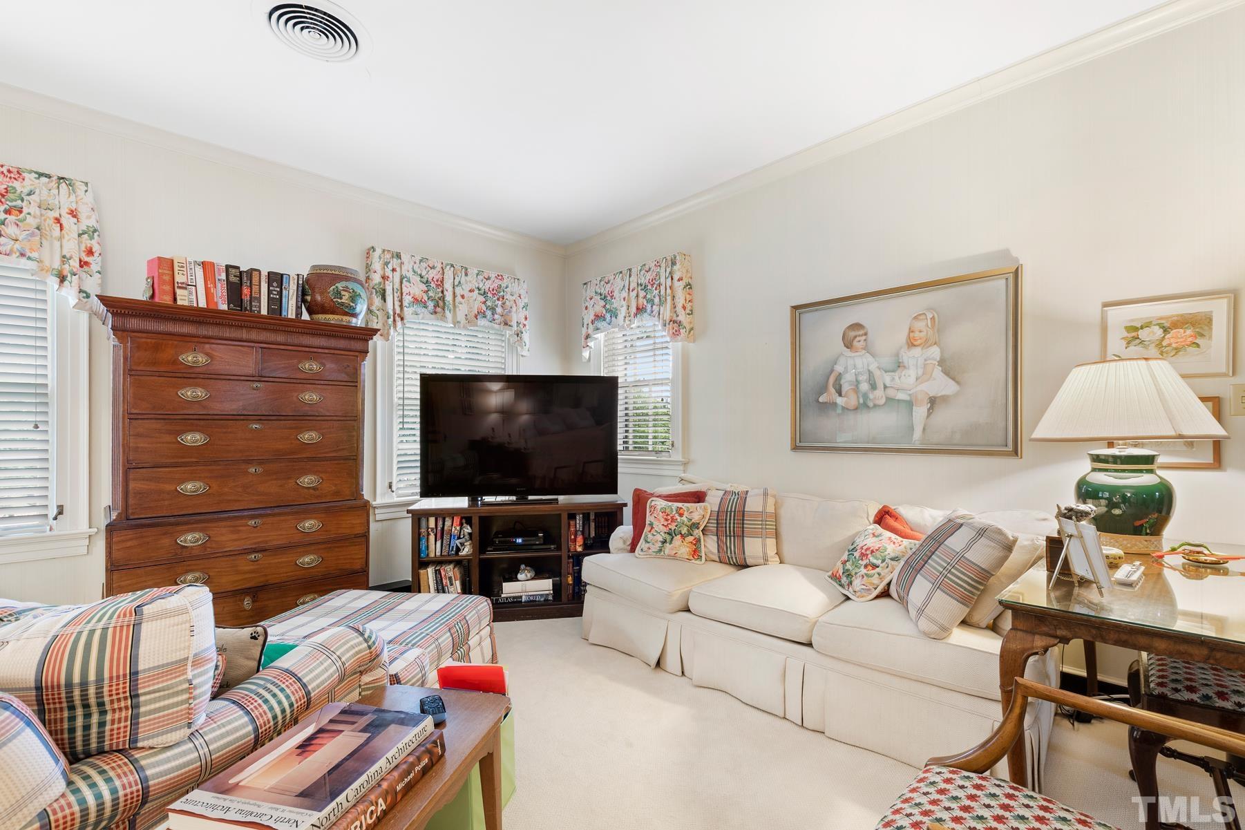1520 Jarvis Street Raleigh, NC 27608 - Photo 32 of 61 a living room with furniture and a flat screen tv