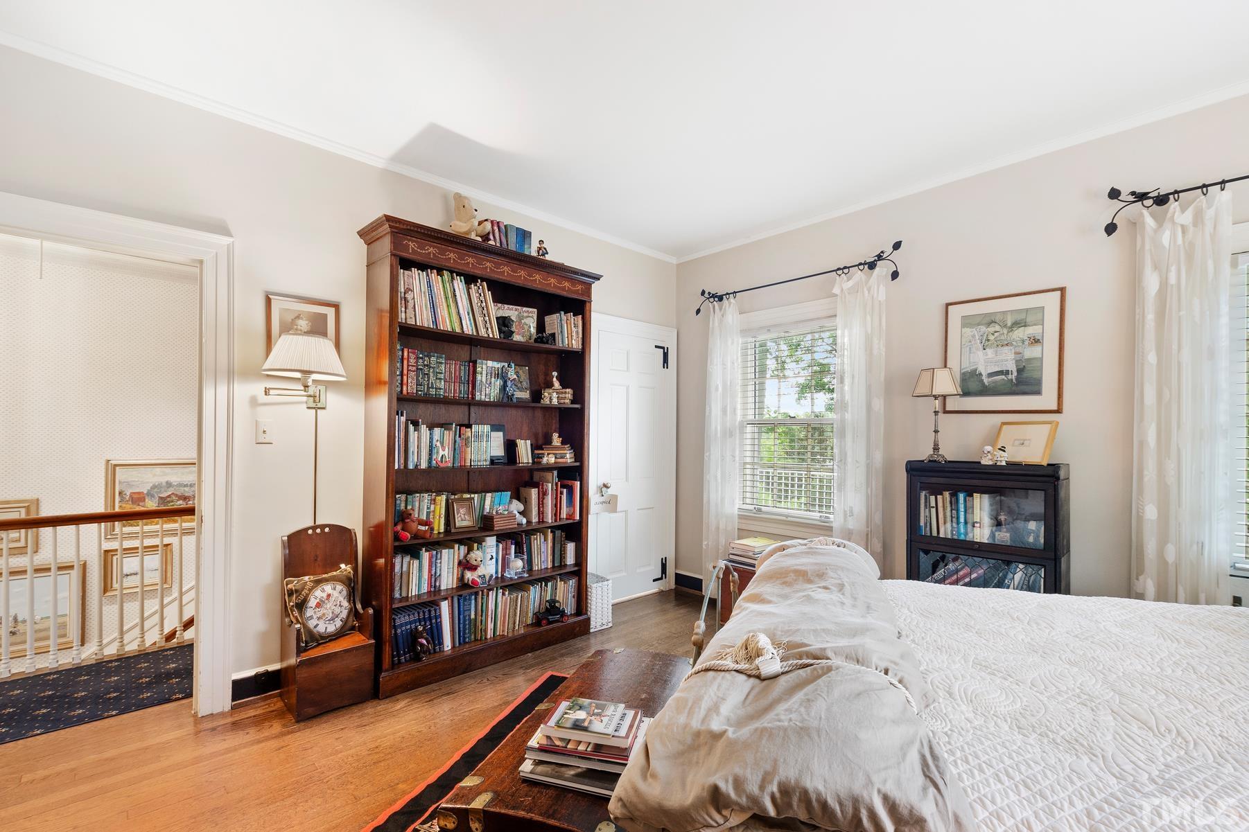 1520 Jarvis Street Raleigh, NC 27608 - Photo 36 of 61 a bed room with a bed and a book shelf