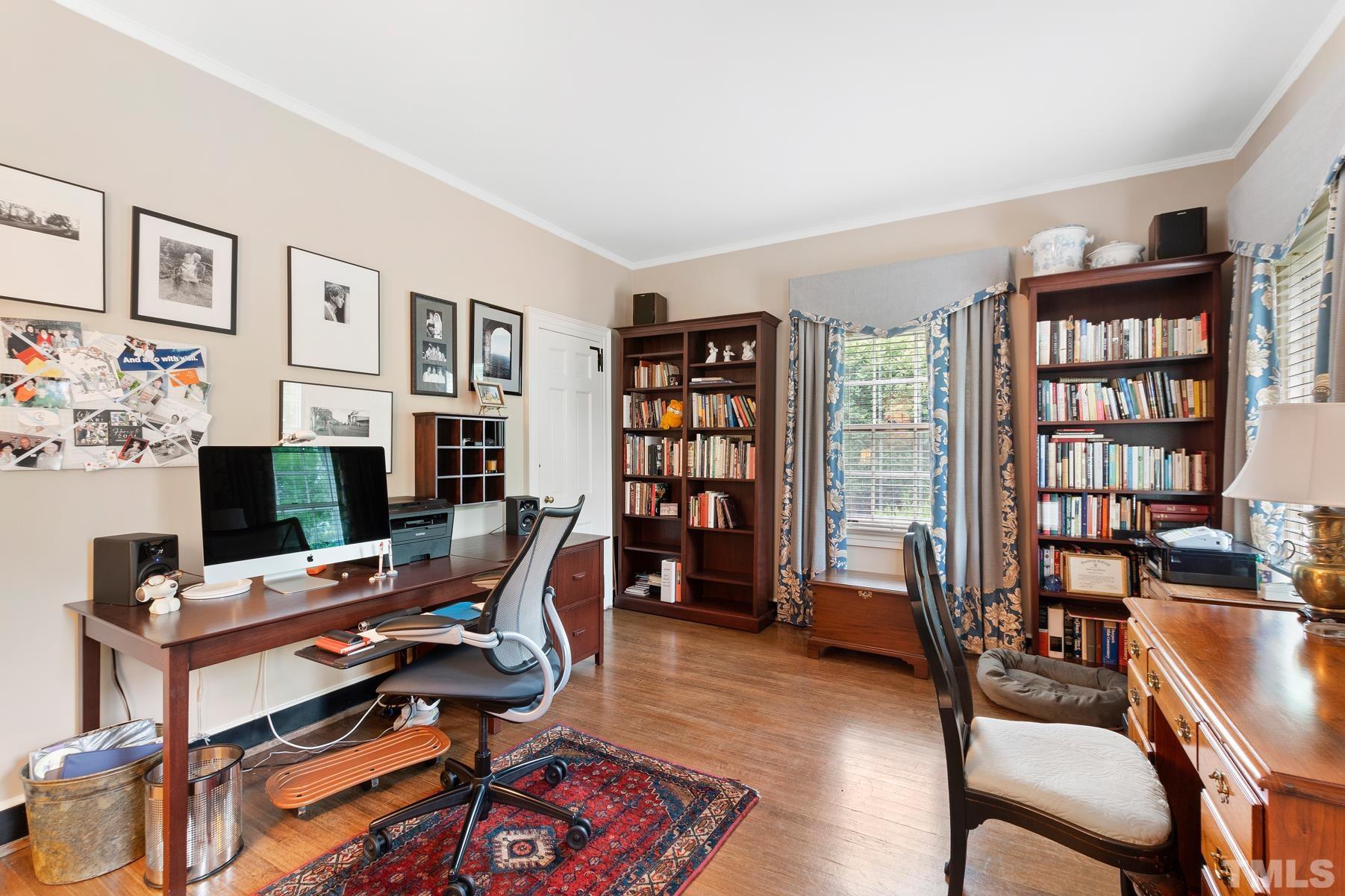 1520 Jarvis Street Raleigh, NC 27608 - Photo 39 of 61 a view of a workspace with bookshelf and a window