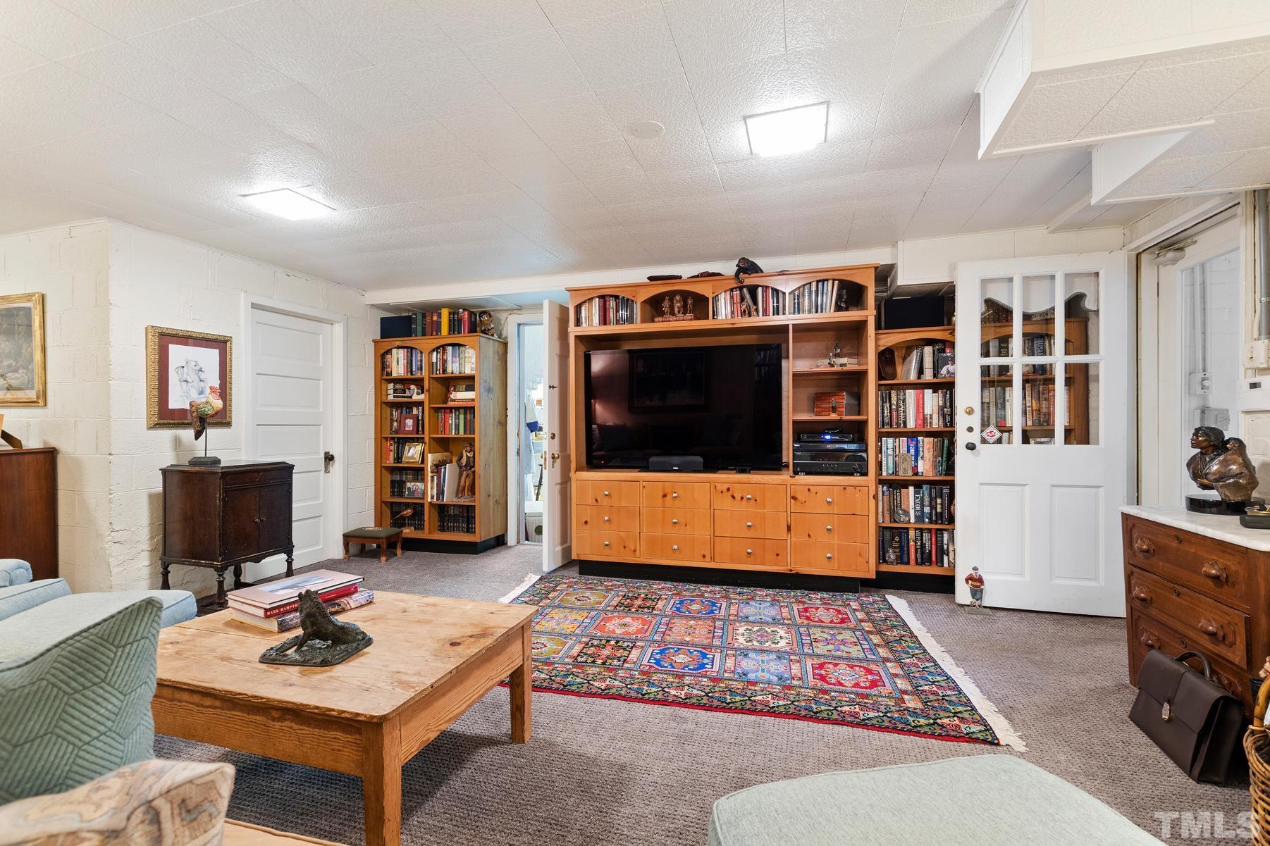 1520 Jarvis Street Raleigh, NC 27608 - Photo 41 of 61 a living room with furniture a rug and a flat screen tv