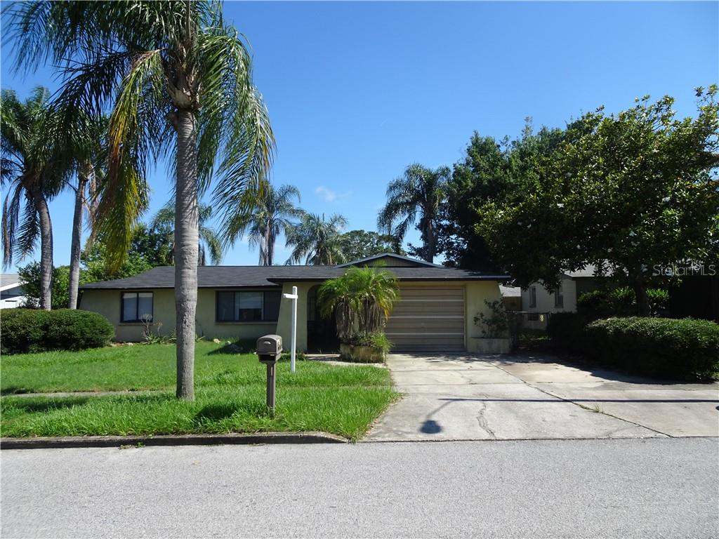 6104 11th Avenue New Port Richey, FL 34653 - Photo 1 of 1 a front view of house with yard and green space