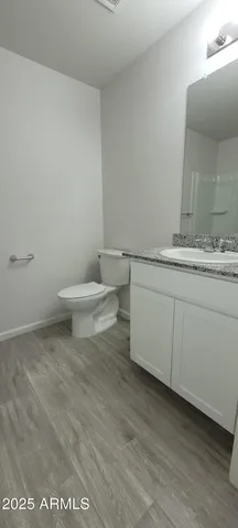 a bathroom with a sink a toilet and mirror