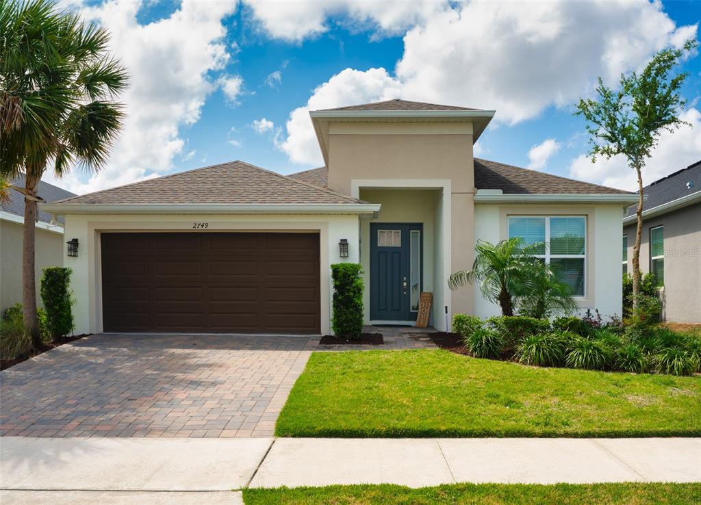 2749 Hilltop Road Clermont, FL 34711 - Photo 1 of 1 a front view of a house with a yard and garage