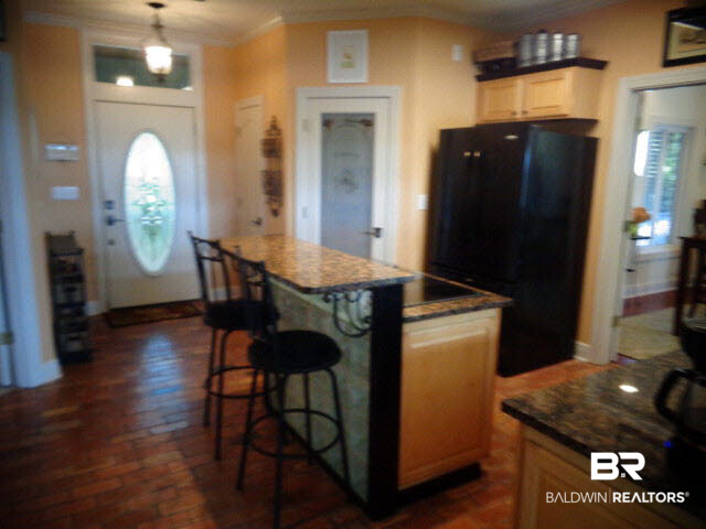 6674 Cook Road Foley, AL 36535 - Photo 12 of 45 16 x 13. Brick floor. Wood cabinets. Center island/breakfast bar with built-in GE Profile electric cooktop. Whirlpool side by side refrigerator. Bar stools convey. Pantry closet. Coat closet.
