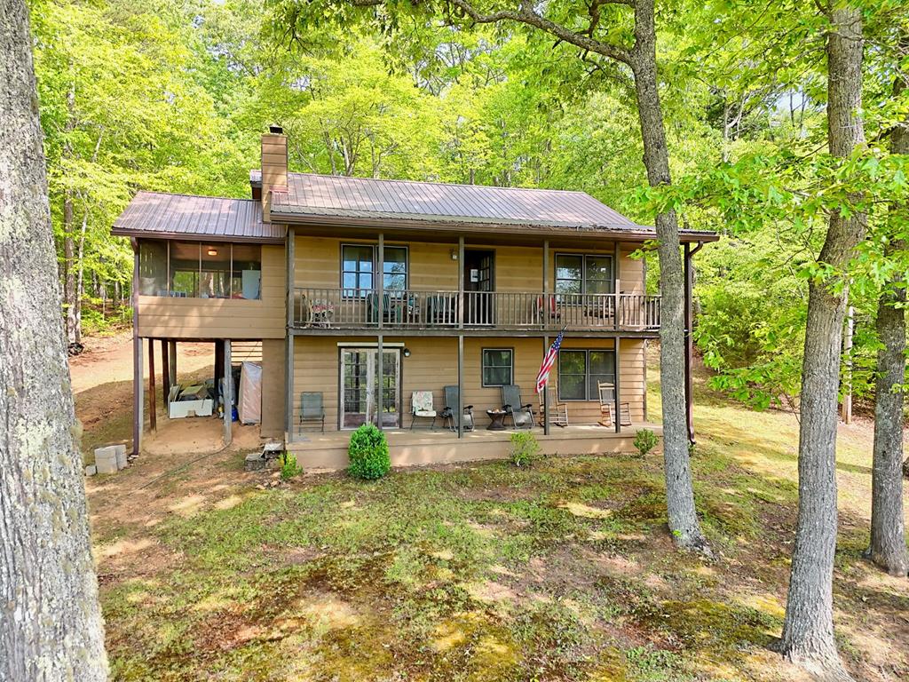 3235 Hiwassee Dam Access Road Murphy, NC 28906 - Photo 1 of 45 a front view of a house with a garden