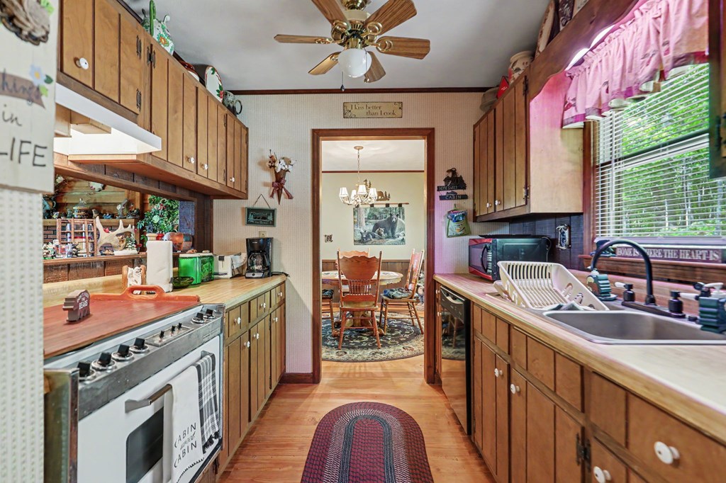 3235 Hiwassee Dam Access Road Murphy, NC 28906 - Photo 24 of 45 a kitchen with stainless steel appliances granite countertop a sink stove and cabinets