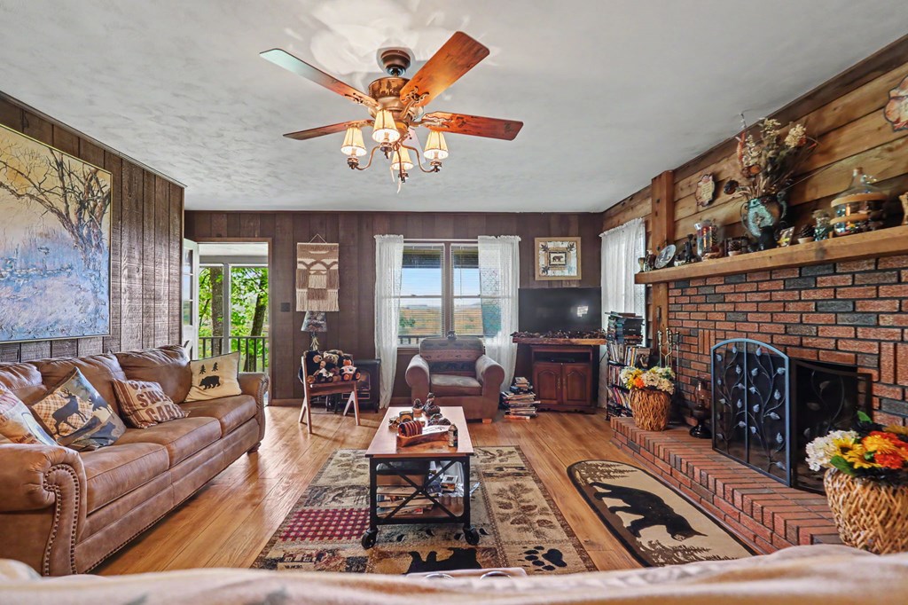 3235 Hiwassee Dam Access Road Murphy, NC 28906 - Photo 29 of 45 a living room with furniture fireplace and a large window