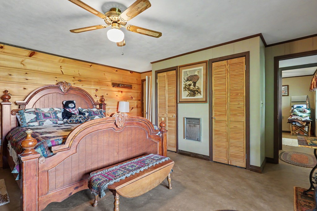3235 Hiwassee Dam Access Road Murphy, NC 28906 - Photo 3 of 45 a bedroom with bed and a chandelier