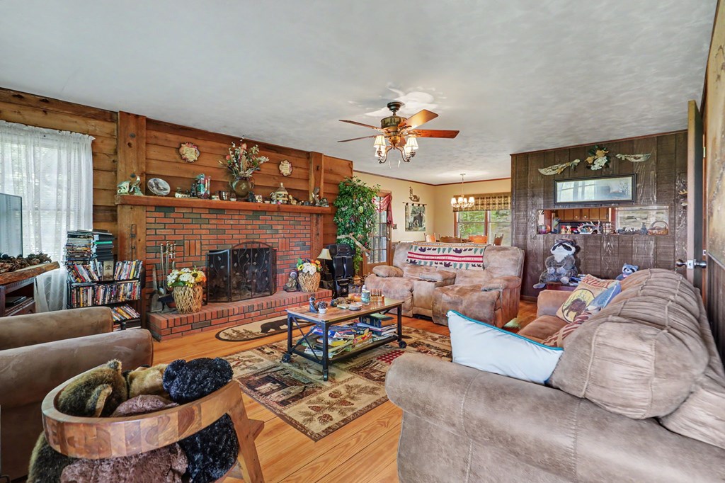 3235 Hiwassee Dam Access Road Murphy, NC 28906 - Photo 36 of 45 a living room with furniture potted plant and a fireplace