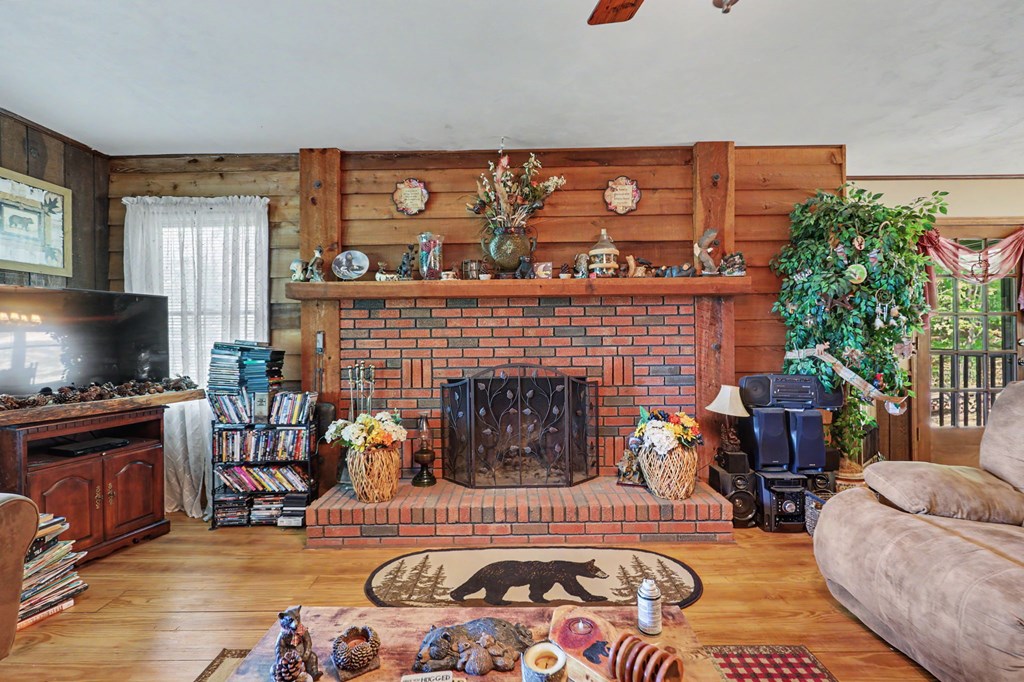 3235 Hiwassee Dam Access Road Murphy, NC 28906 - Photo 37 of 45 a living room with furniture a flat screen tv and a fireplace