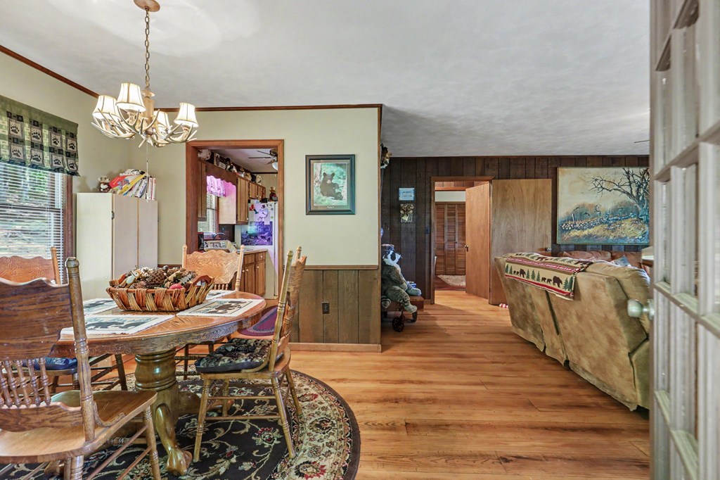 3235 Hiwassee Dam Access Road Murphy, NC 28906 - Photo 40 of 45 a dining room with furniture a chandelier and wooden floor