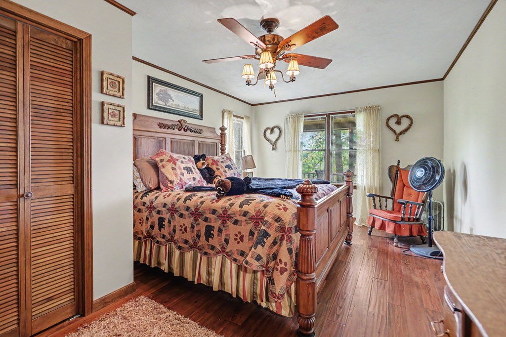 3235 Hiwassee Dam Access Road Murphy, NC 28906 - Photo 41 of 45 a bed room with a bed and a chandelier