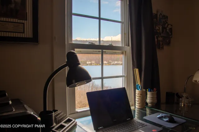 a living room with furniture and paintings on the wall