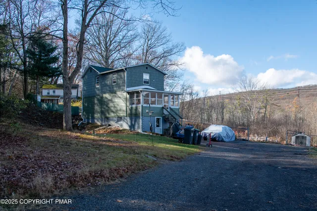 a view of a house with a door and wooden walls