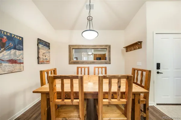 a view of a dining room with furniture wooden floor and front door