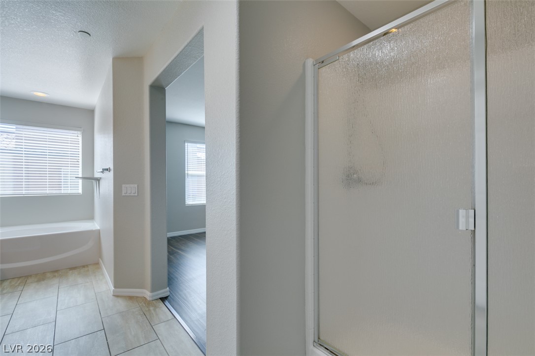 4650 Ranch House Road, Unit 46 North Las Vegas, NV 89031 - Photo 29 of 38 A spacious layout connects the tiled bath area to adjacent rooms.
