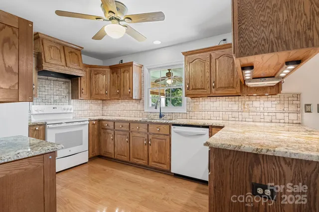 a view of a hallway with wooden floor and a bathroom