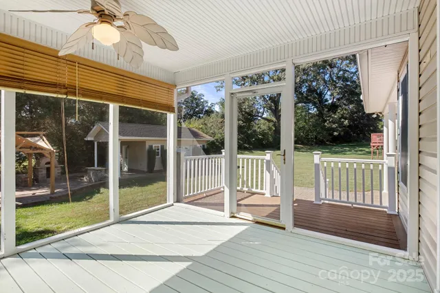 a view of a room with a floor to ceiling window and wooden floor