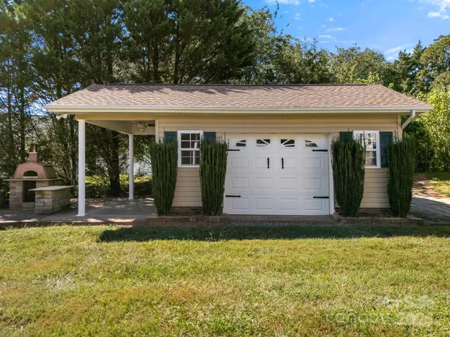 a view of a house with backyard and glass windows