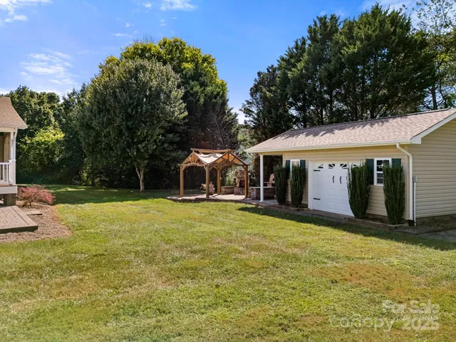 a view of a house with backyard porch and sitting area