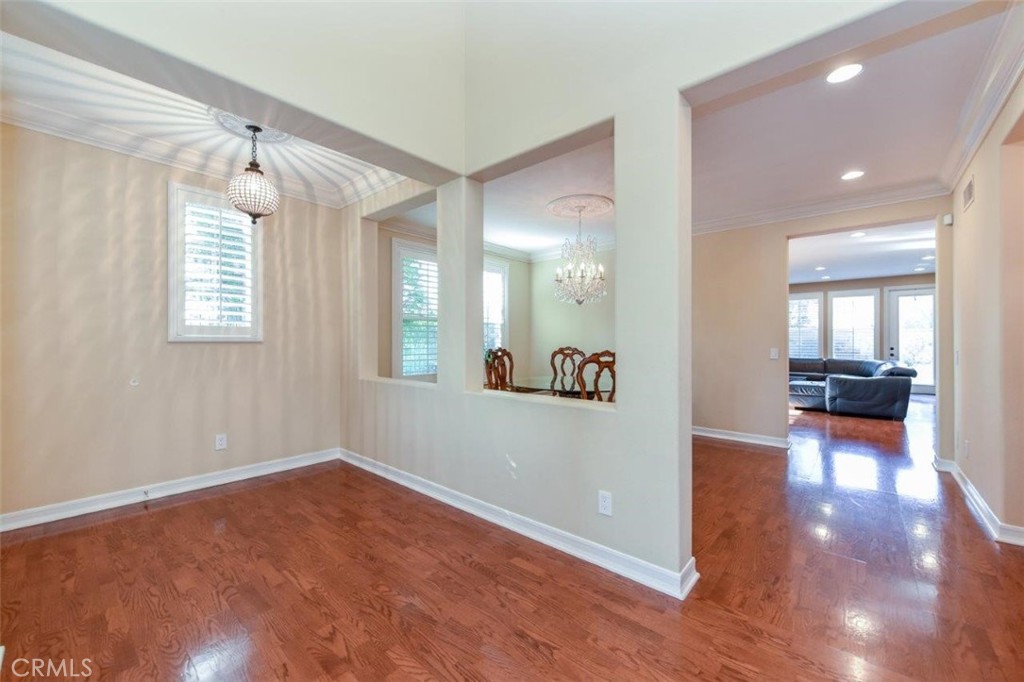3 Plumbago Irvine, CA 92620 - Photo 11 of 51 a view of a hallway with wooden floor and a living room