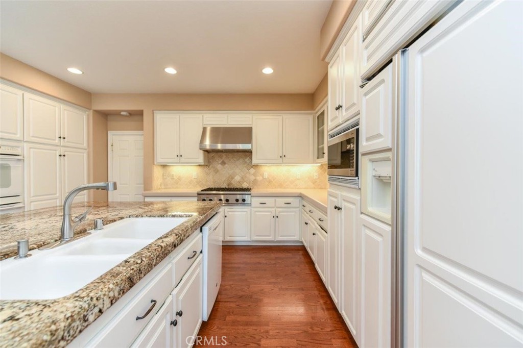 3 Plumbago Irvine, CA 92620 - Photo 20 of 51 a kitchen with granite countertop a sink stove and cabinets