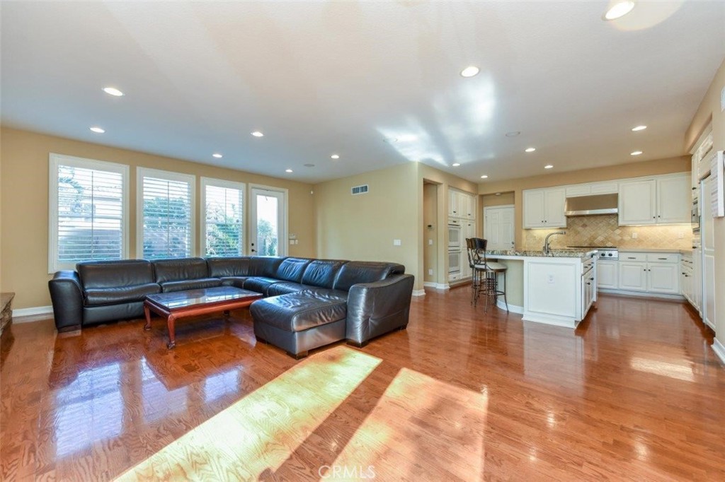 3 Plumbago Irvine, CA 92620 - Photo 23 of 51 a living room with furniture and kitchen view with wooden floor