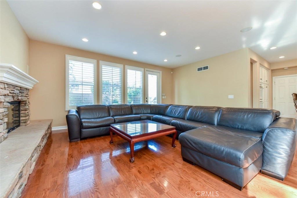 3 Plumbago Irvine, CA 92620 - Photo 25 of 51 a living room with furniture a rug and a flat screen tv