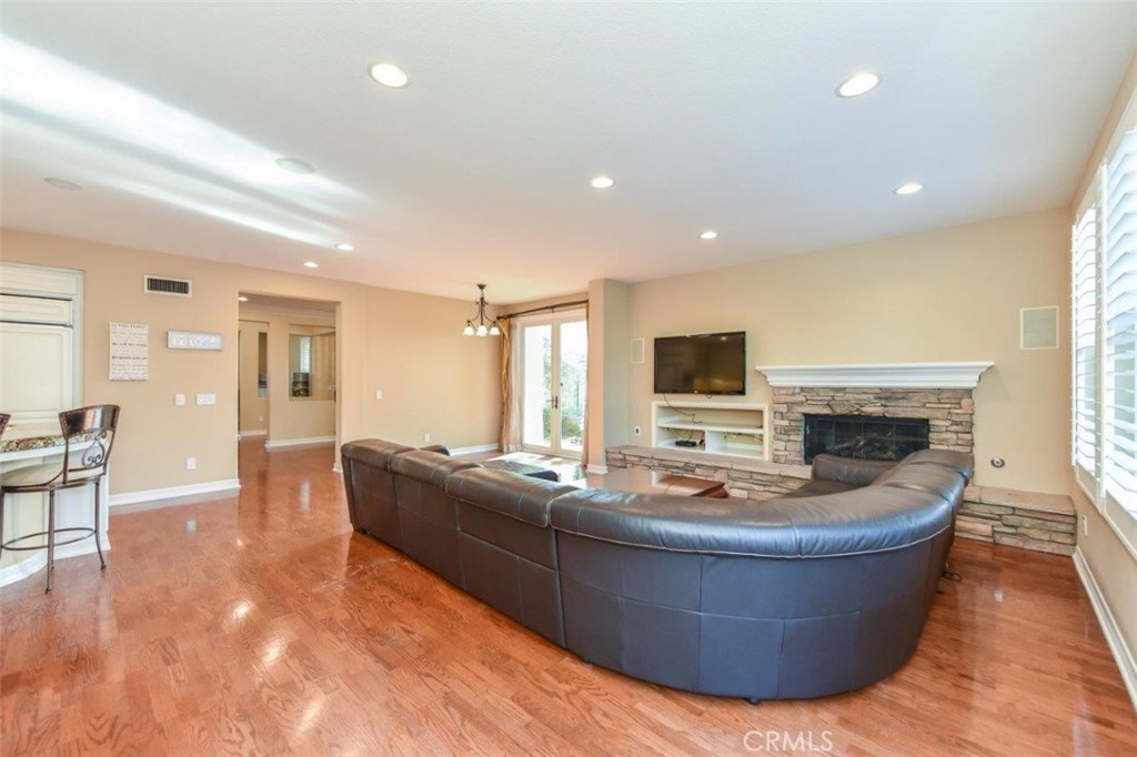 3 Plumbago Irvine, CA 92620 - Photo 26 of 51 a living room with fireplace furniture and a flat screen tv