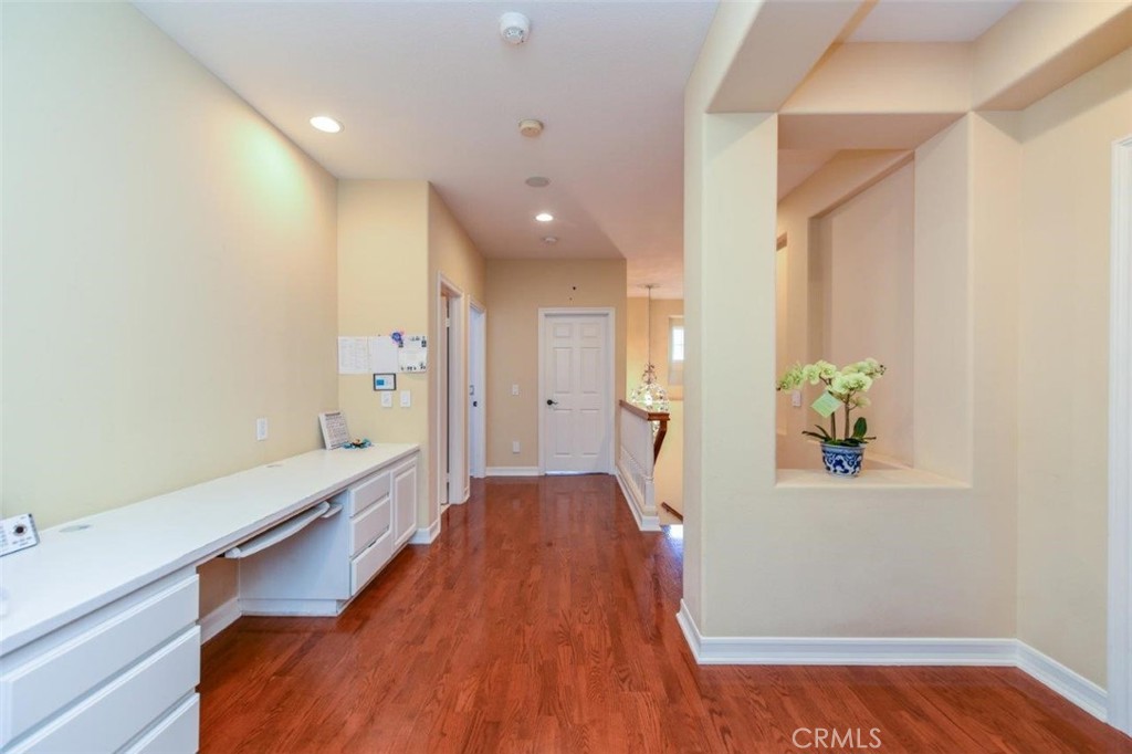 3 Plumbago Irvine, CA 92620 - Photo 30 of 51 a hallway with a wooden floor and a bathroom