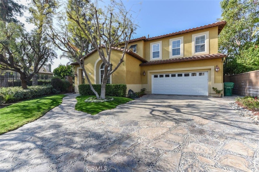 3 Plumbago Irvine, CA 92620 - Photo 4 of 51 a front view of a house with a yard and garage