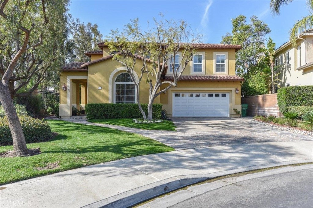 3 Plumbago Irvine, CA 92620 - Photo 5 of 51 a front view of a house with a yard and a garage