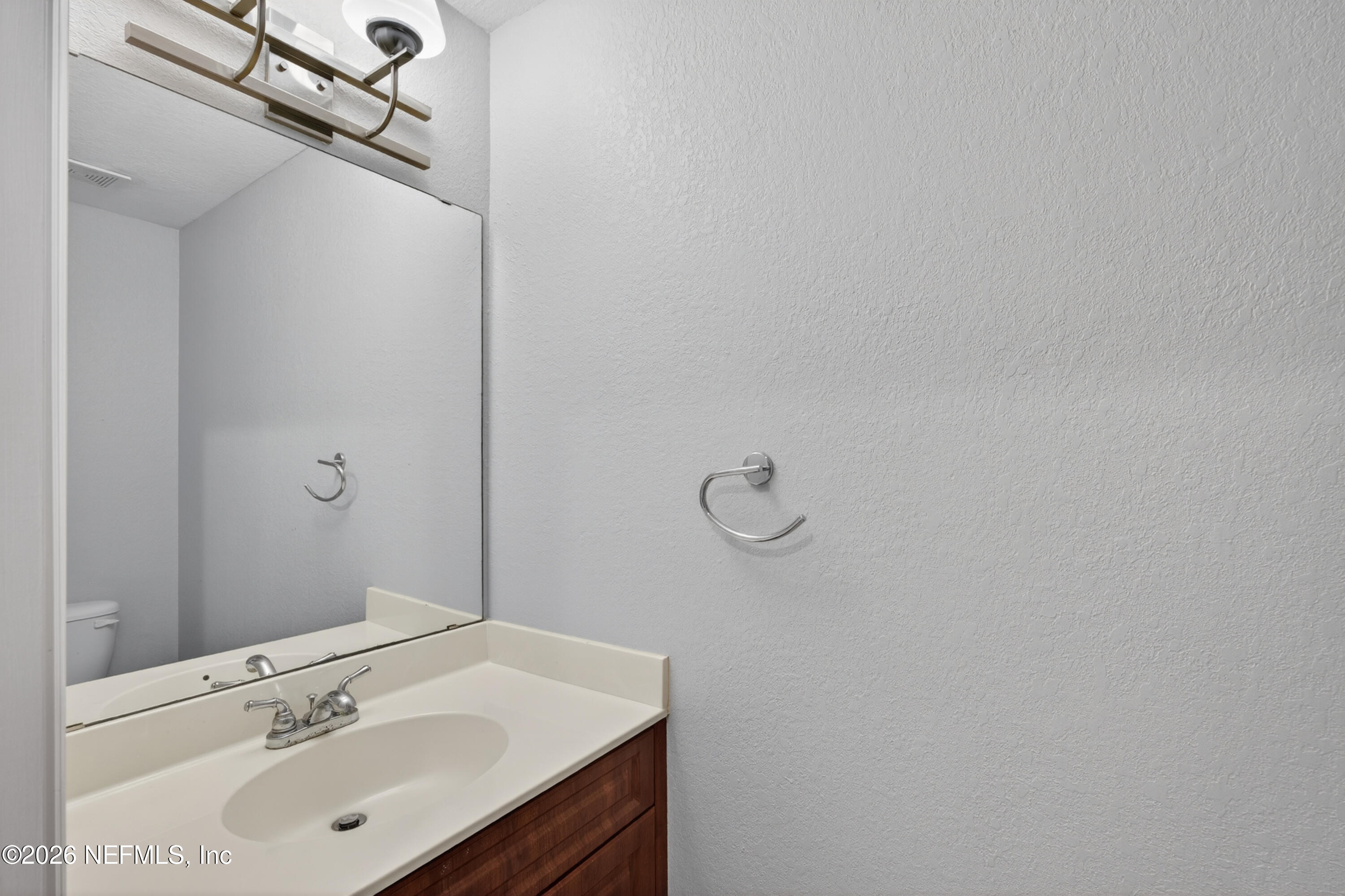 9745 Touchton Road, Unit 1224 Jacksonville, FL 32246 - Photo 20 of 22 a bathroom with a sink and a mirror