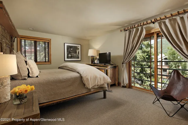 a bed sitting in a bedroom next to a window