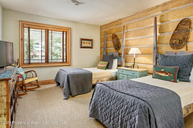 a bedroom with two beds and a window