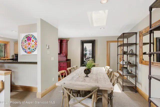 a view of a dining room with furniture and a bookshelf