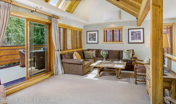 a living room with furniture and a floor to ceiling window