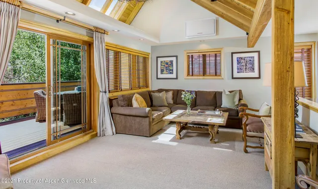 a living room with furniture and a floor to ceiling window