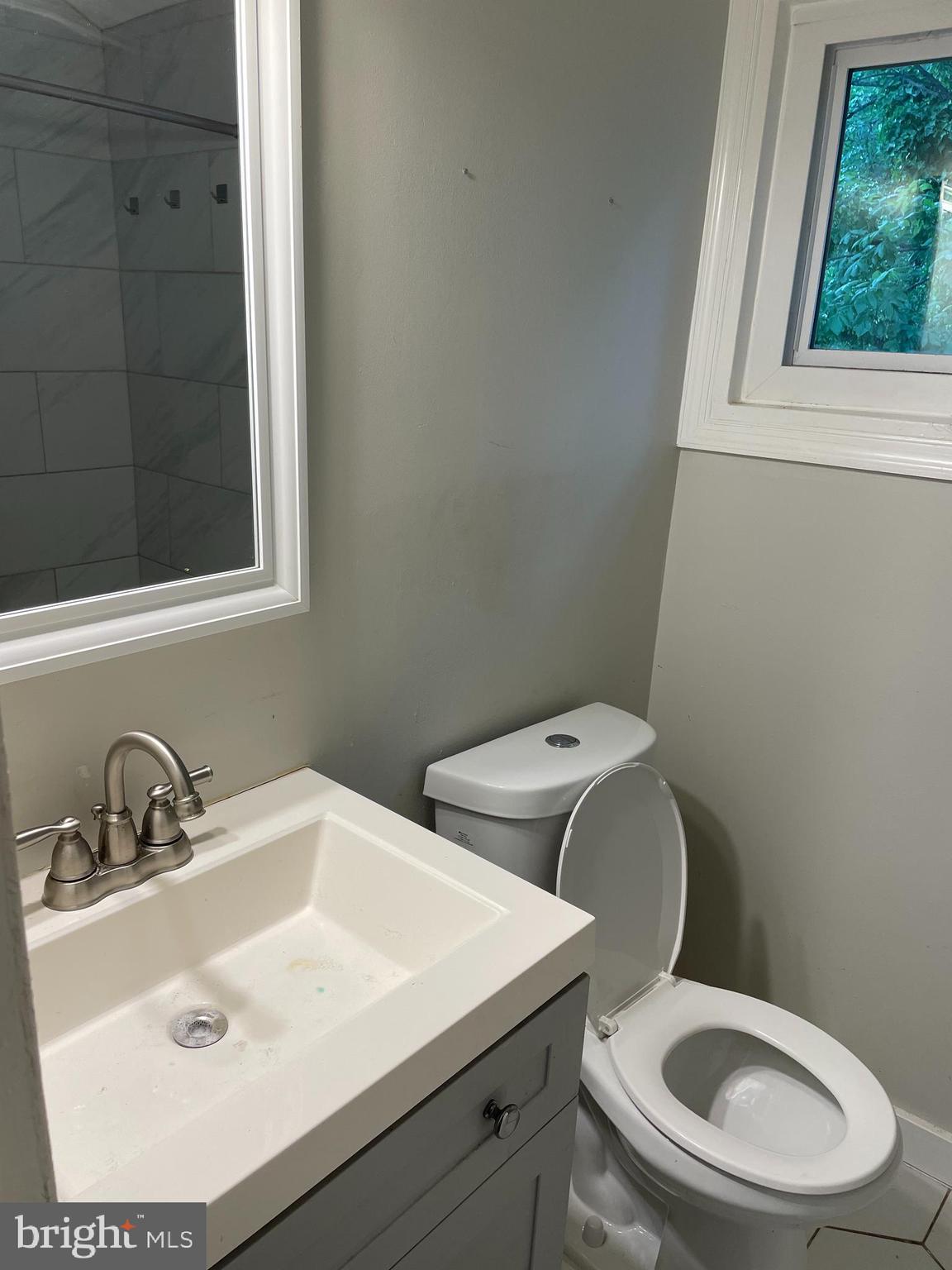 2307 Wyngate Road Suitland, MD 20746 - Photo 14 of 22 a bathroom with a toilet sink and mirror