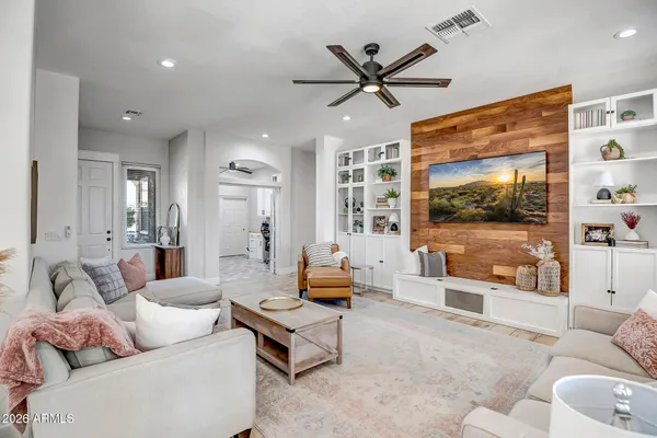 a living room with furniture a window and a chandelier