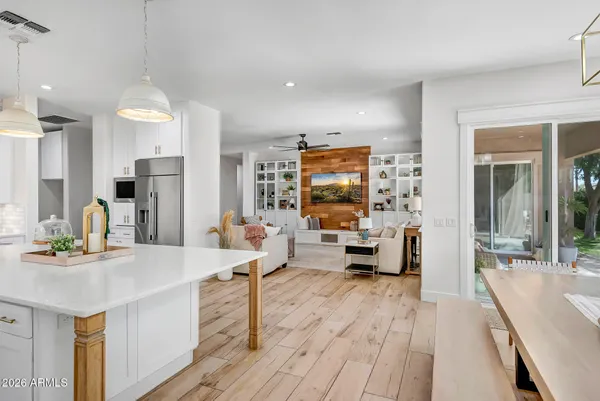 a living room with furniture ceiling fan and a flat screen tv