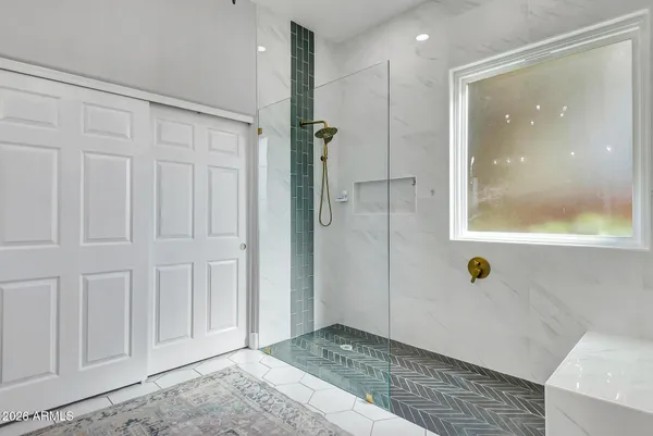 a spacious bathroom with a mirror sink and vanity