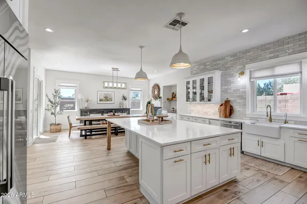a large kitchen with kitchen island a sink stainless steel appliances and cabinets